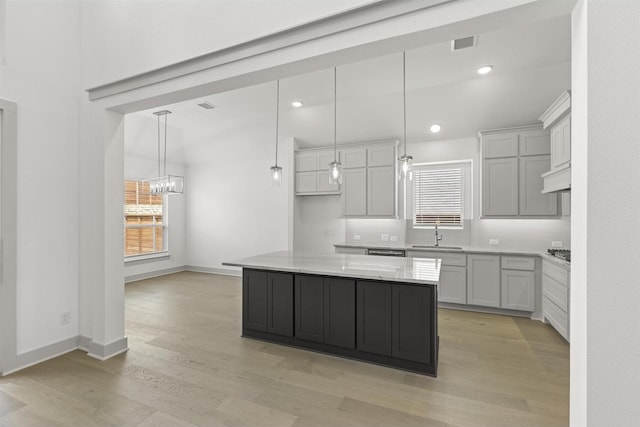 1841 Jasmine June, Mesquite, TX 75181 - kitchen with an inviting chandelier, visible vents, a center island, light stone countertops, and light wood-style floors