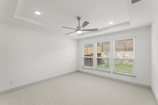 1841 Jasmine June, Mesquite, TX 75181 - unfurnished room with a raised ceiling, baseboards, a ceiling fan, and light colored carpet