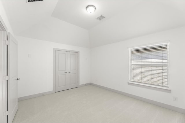 1841 Jasmine June, Mesquite, TX 75181 - unfurnished bedroom with a closet, light carpet, vaulted ceiling, and visible vents