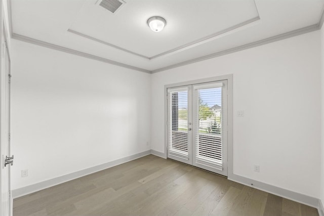 1841 Jasmine June, Mesquite, TX 75181 - empty room featuring french doors, visible vents, crown molding, a raised ceiling, and light wood-style floors
