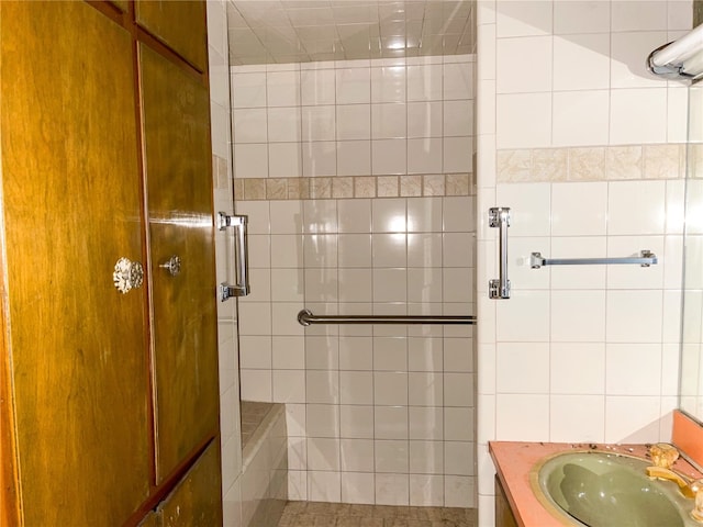 bathroom with vanity and tiled shower