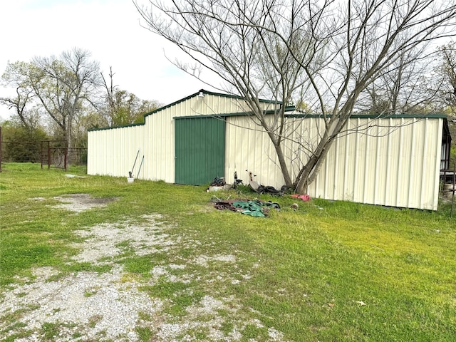 view of outdoor structure featuring a lawn