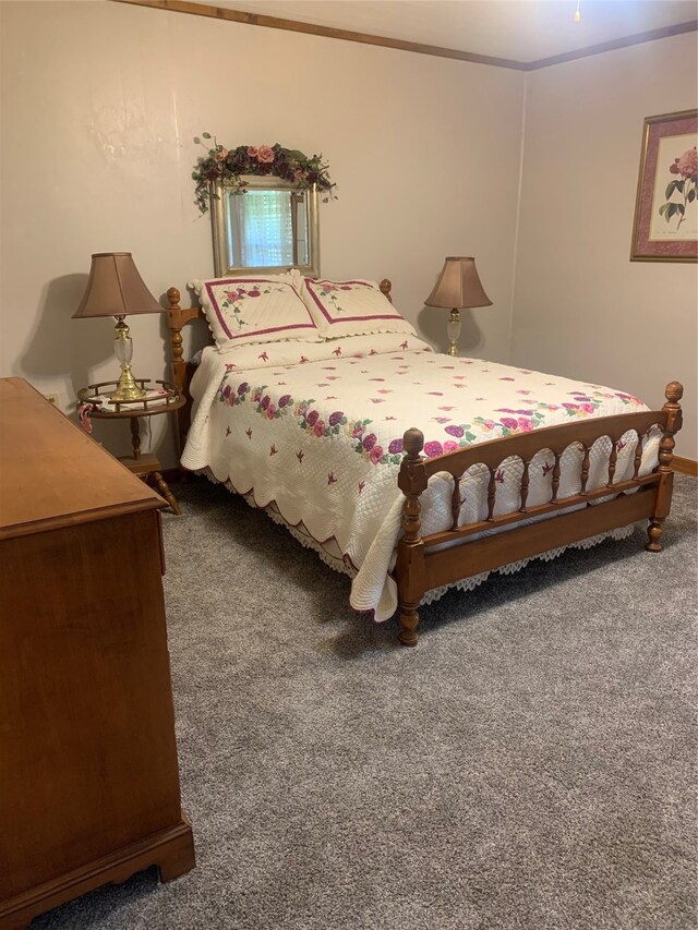 carpeted bedroom with ornamental molding