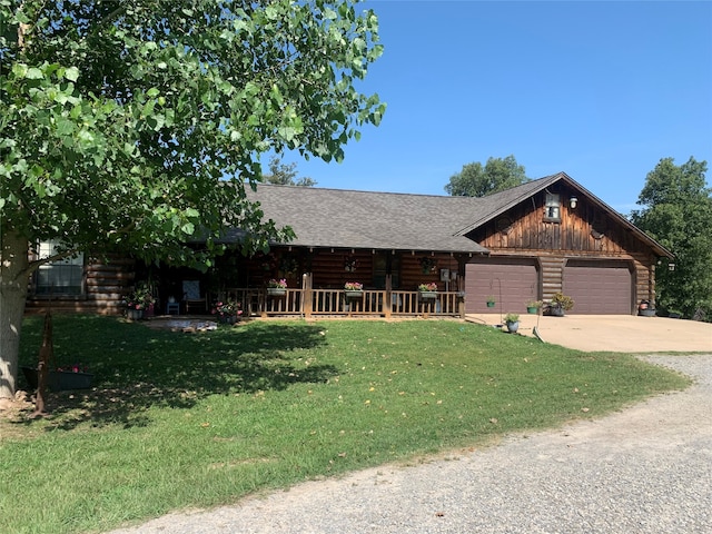 cabin featuring a garage and a front yard