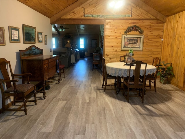 dining area featuring wood walls, wooden ceiling, lofted ceiling, and hardwood / wood-style floors