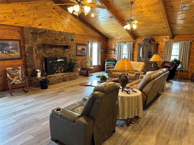 living room featuring a fireplace, hardwood / wood-style flooring, vaulted ceiling with beams, and ceiling fan