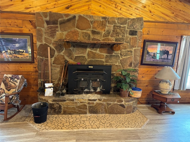 interior details featuring a stone fireplace, wood-type flooring, and wooden ceiling