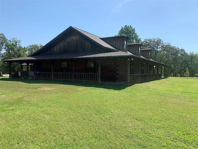 rear view of property featuring a yard