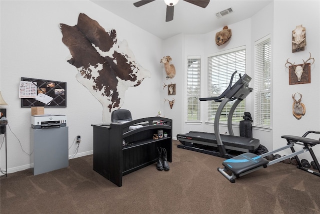 exercise area with dark colored carpet and ceiling fan