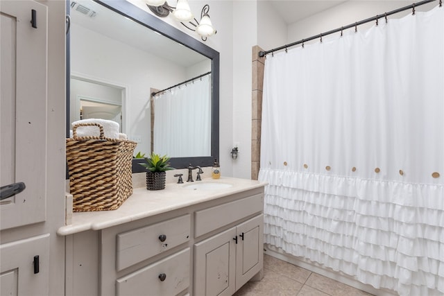 bathroom with tile patterned flooring and vanity