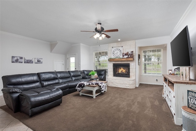 carpeted living room with a fireplace, ornamental molding, ceiling fan, and a wealth of natural light