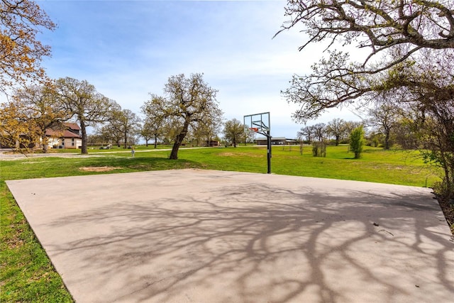 view of sport court with a yard