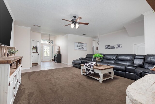 carpeted living room featuring ceiling fan with notable chandelier, a textured ceiling, and crown molding