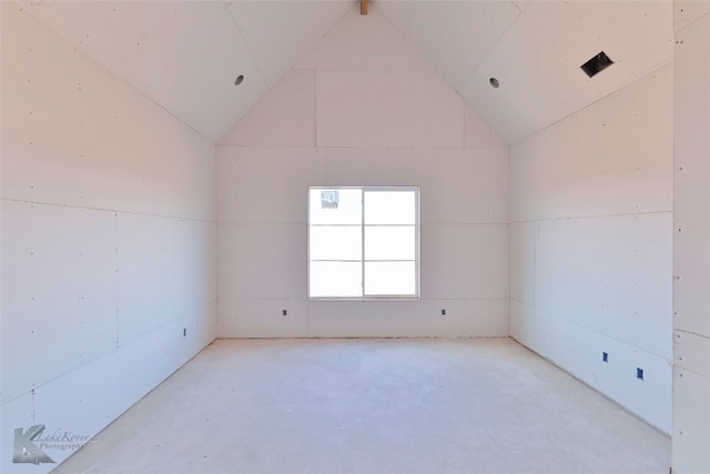 unfurnished room with lofted ceiling