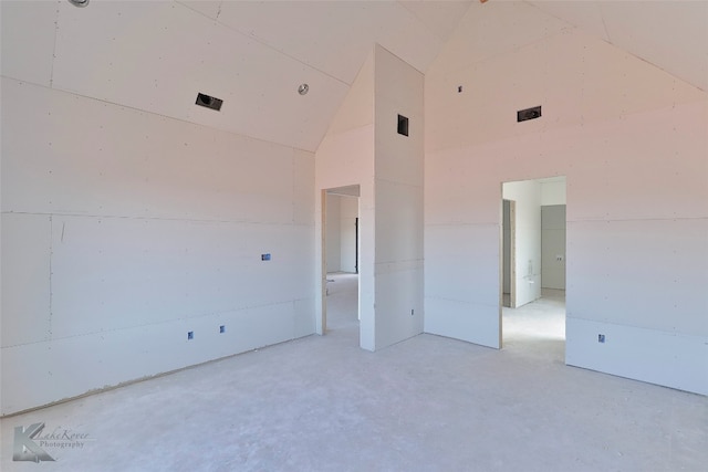 unfurnished room featuring lofted ceiling