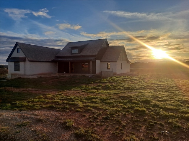 view of back house at dusk