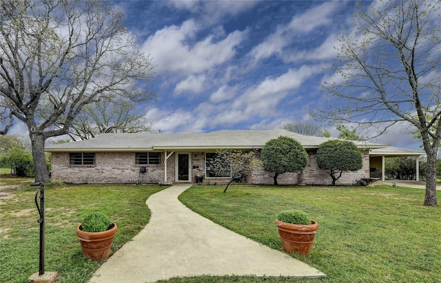 ranch-style house featuring a front yard and a carport