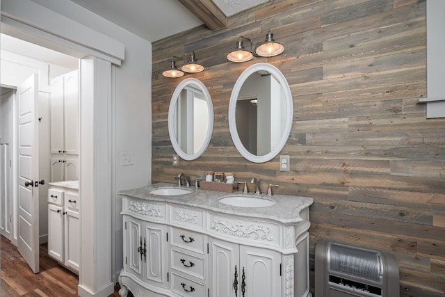 bathroom with wooden walls, beam ceiling, wood-type flooring, and double sink vanity