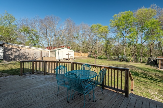 deck with a lawn and a shed