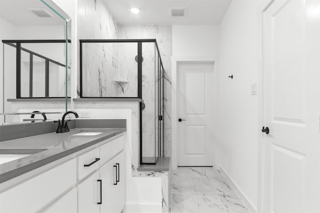 bathroom with vanity and a shower with door