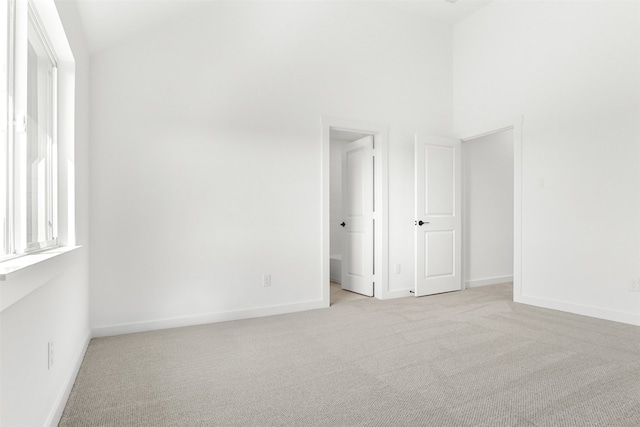 unfurnished room featuring light carpet