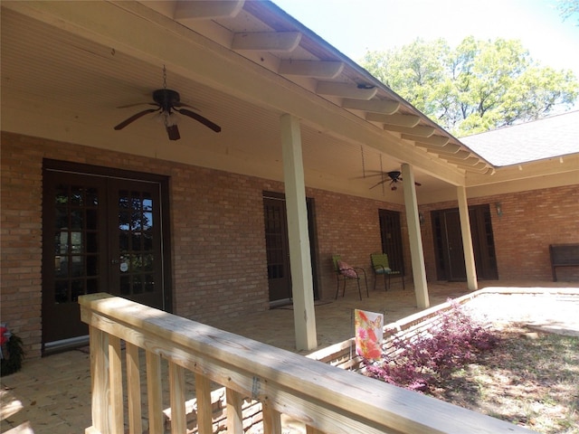 view of terrace with ceiling fan and french doors