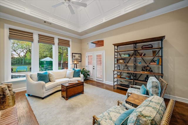 living room with coffered ceiling, french doors, wood-type flooring, ceiling fan, and ornamental molding