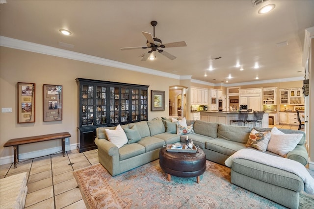 living room featuring ornamental molding, ceiling fan, and light tile floors