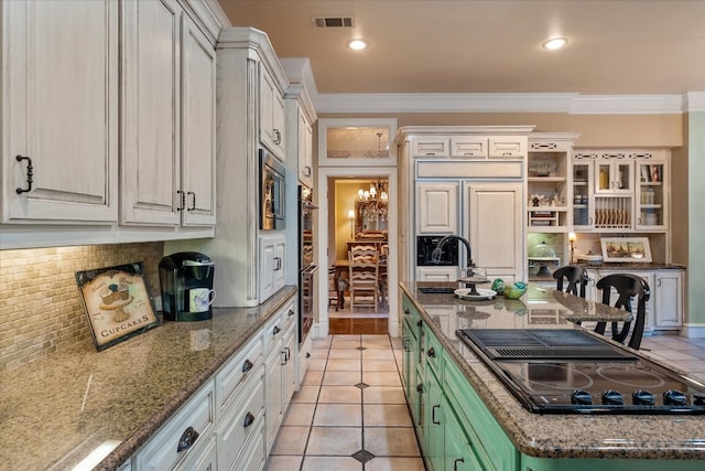 kitchen with a notable chandelier, backsplash, white cabinetry, and ornamental molding