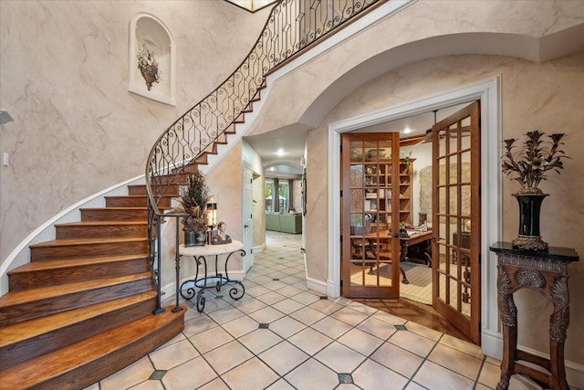 foyer entrance with french doors and light tile floors