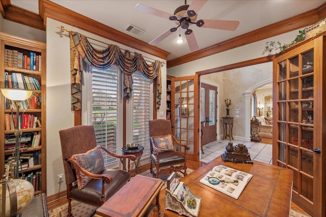 sitting room with light tile flooring, ceiling fan, crown molding, and french doors