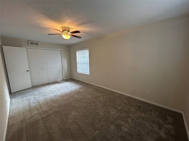 unfurnished bedroom featuring a closet, ceiling fan, and light colored carpet