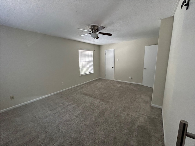 carpeted spare room with a textured ceiling and ceiling fan