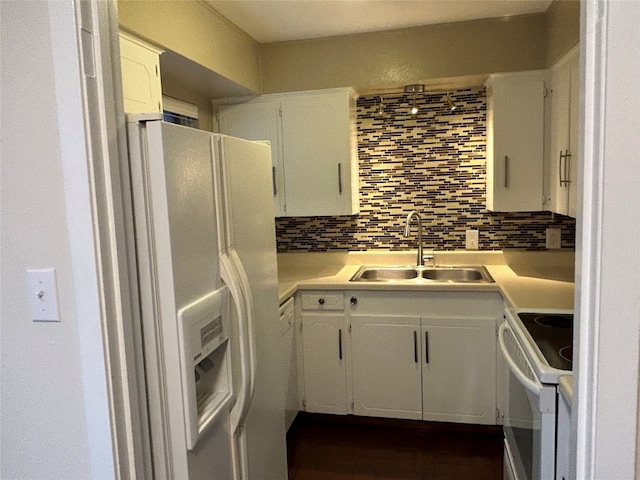 kitchen featuring backsplash, white appliances, white cabinets, and sink