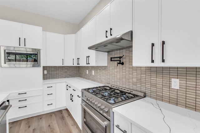 kitchen featuring decorative backsplash, light hardwood / wood-style flooring, stainless steel appliances, and white cabinets