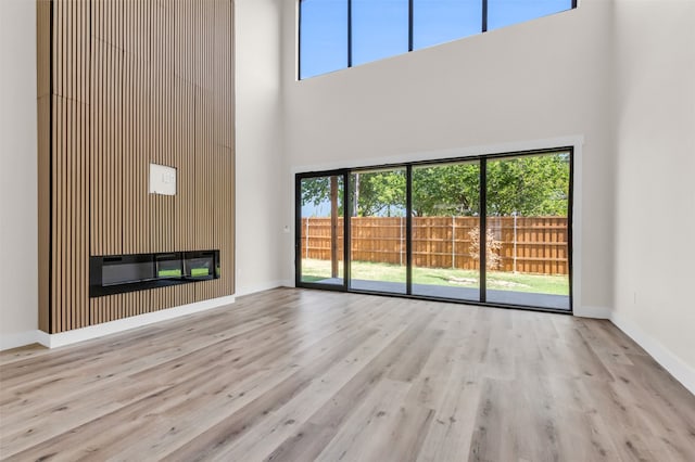 unfurnished living room featuring light hardwood / wood-style flooring and plenty of natural light