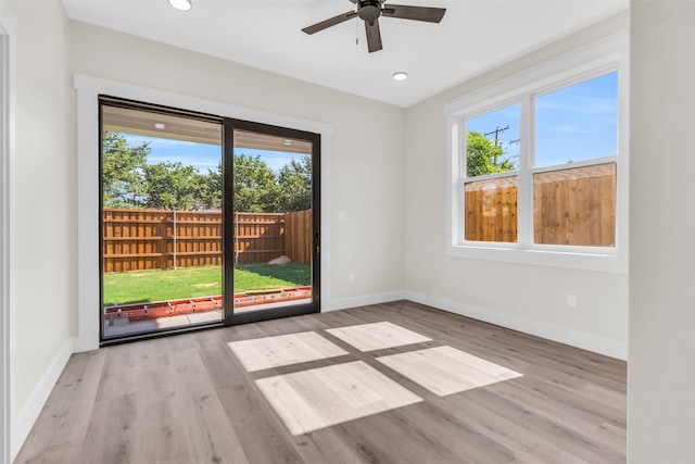 spare room with light wood-type flooring and ceiling fan