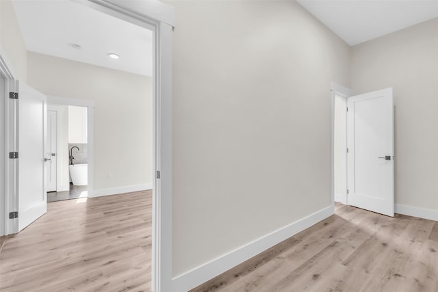 corridor with light hardwood / wood-style floors