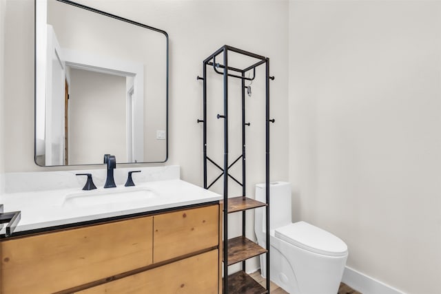 bathroom featuring vanity, toilet, and wood-type flooring