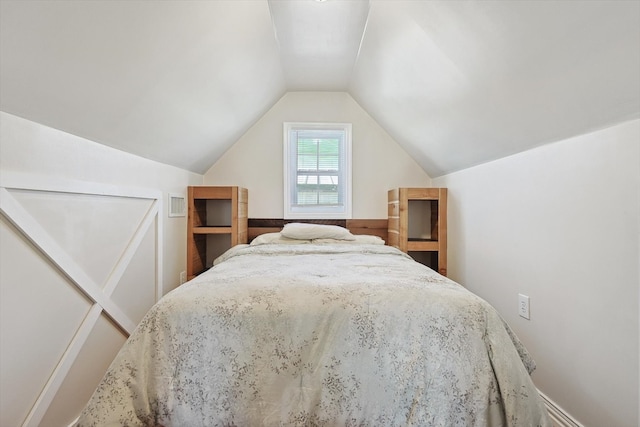 bedroom with lofted ceiling