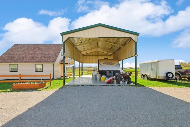 view of vehicle parking with a detached carport and driveway