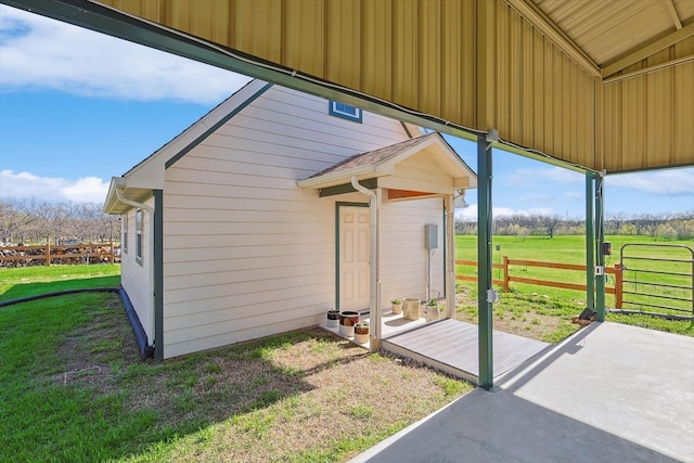 view of side of property with a yard and a patio