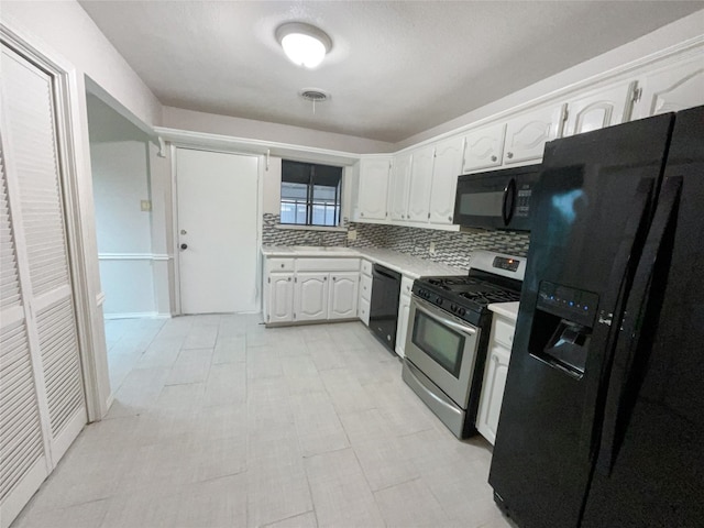 kitchen with backsplash, white cabinets, black appliances, and light tile floors