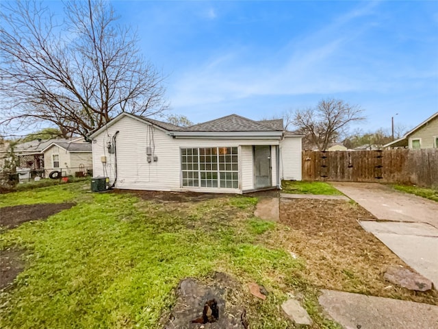 back of property with a lawn and central AC unit