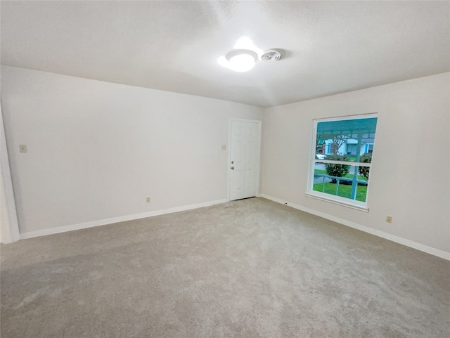 empty room featuring light colored carpet