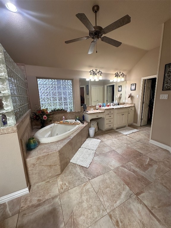 bathroom featuring double sink, a relaxing tiled bath, vanity with extensive cabinet space, ceiling fan, and tile floors