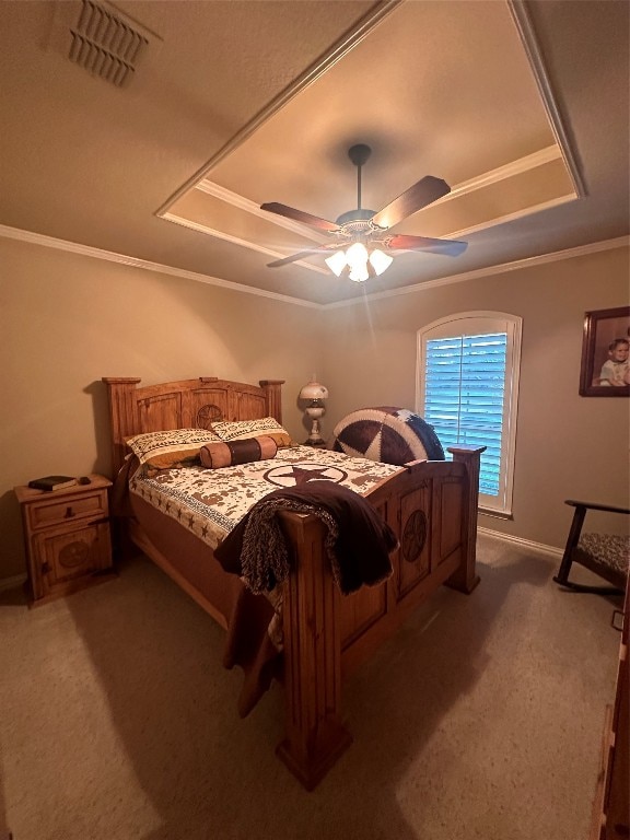 bedroom featuring dark carpet, ceiling fan, and a tray ceiling