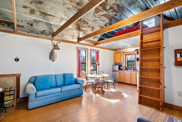 living room with beam ceiling, sink, and hardwood / wood-style flooring