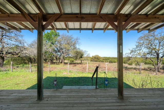 wooden deck featuring a yard and a rural view