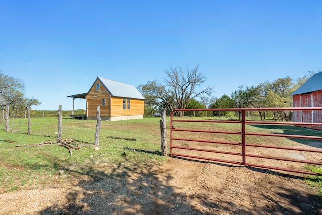 view of yard featuring an outbuilding and a rural view